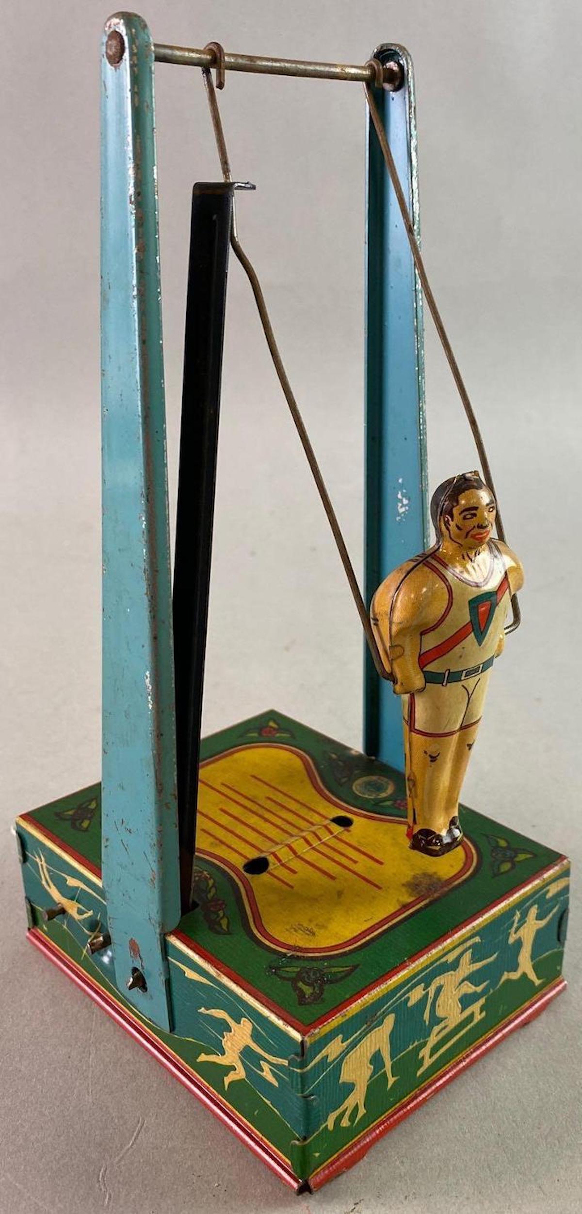 Wyandotte Gymnast Wind Up Tin Toy: Working but sticks. Measures approximately 9 x 4 1/2 inches.