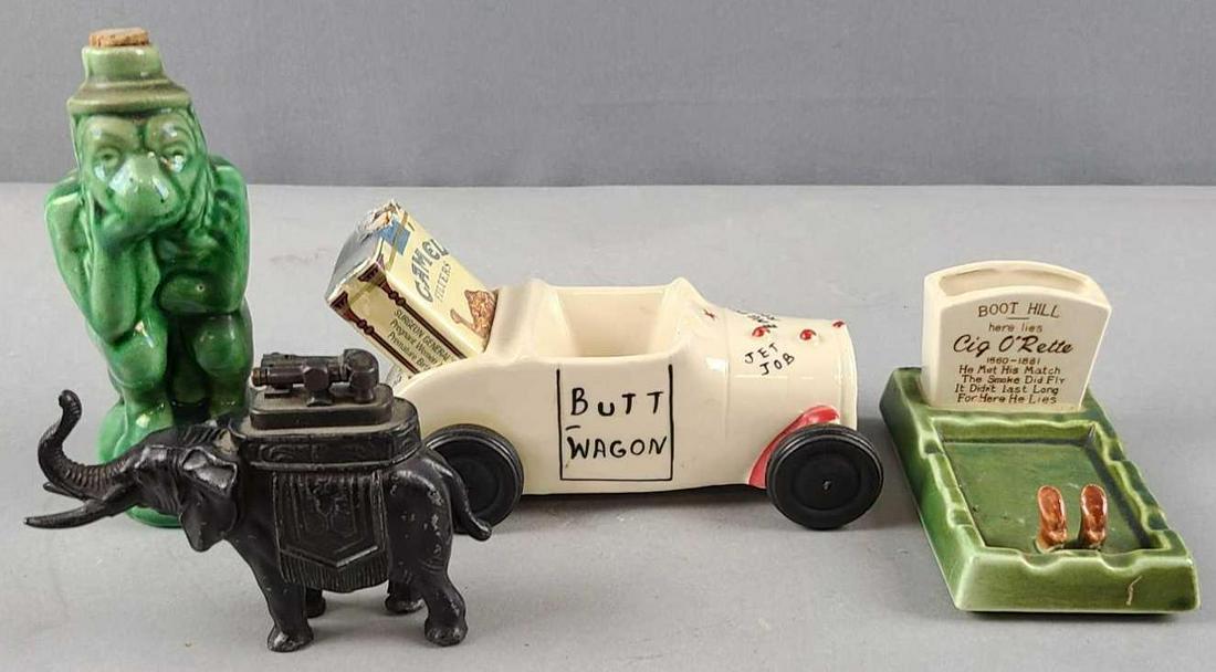 Group of ashtrays, lighter, decanter: Butt wagon, elephant lighter, Boot Hill cemetery ashtray