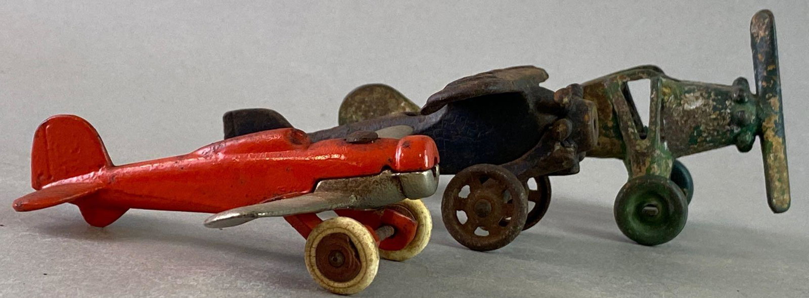 Group of 3 cast Iron Die Cast Airplanes: Largest measures approximately 5 1/2 x 3 inches.