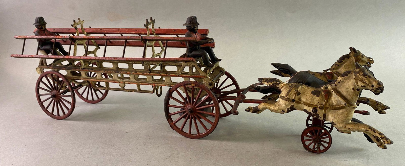 Antique Cast Iron Horse Drawn Fire Ladder Wagon: Measures approximately 21 1/2 x 6 1/2 x 5 inches. Rear axle Mount broken.