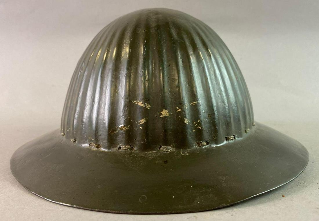 WW1 Portuguese M15 Helmet: Repainted for Post War Use. Liner is next generation. Hand painted crossed sabers decal.