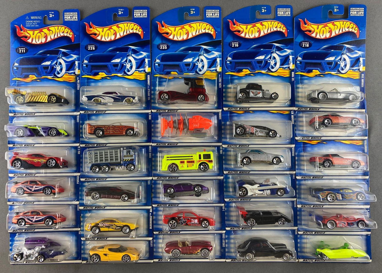 Group of 30 assorted Hot Wheels die-cast vehicles: c. 2000, includes Shelby Cobra 427 S/C, Semi-Fast, 65 Impala, and more. New in original packaging