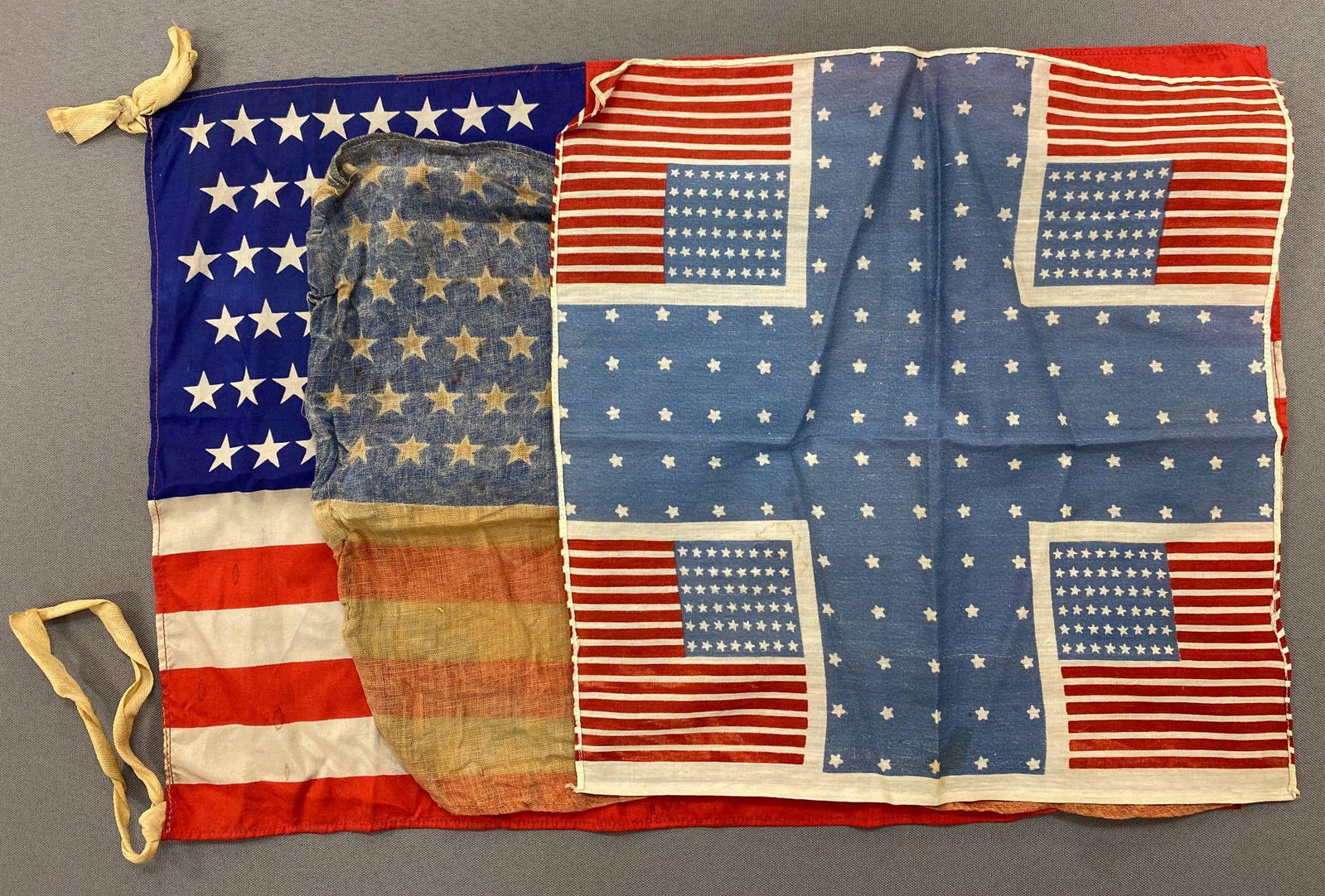 Group of 3 48 Star Flags and Handkerchief: The largest flag measures 11 1/2 x 17 1/2 inches and is made of silk. Flags have some damage.