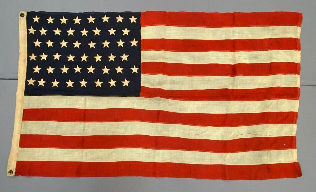 Vintage 48 Star Flag: Stripes are sewn together. Measures 34 x 58 inches. Has some holes and staining.