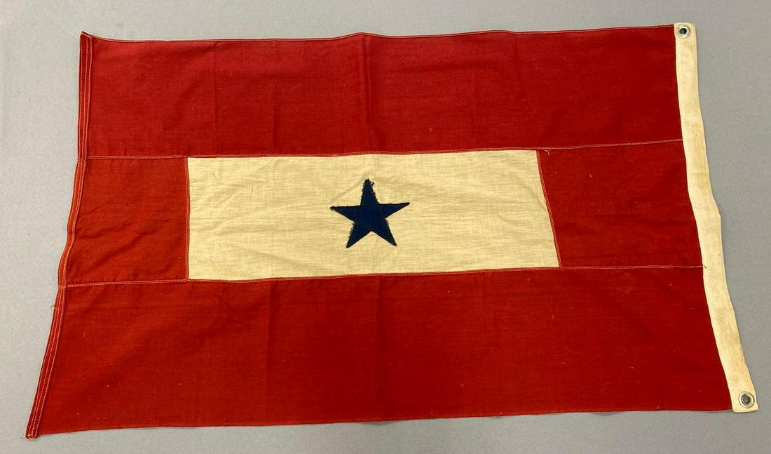 Blue Star Service Flag: Measures 22.5x36.5 inches. In fair condition. Some staining. Rip along red side and tear in center white area. Measures 22x13.5 inches.