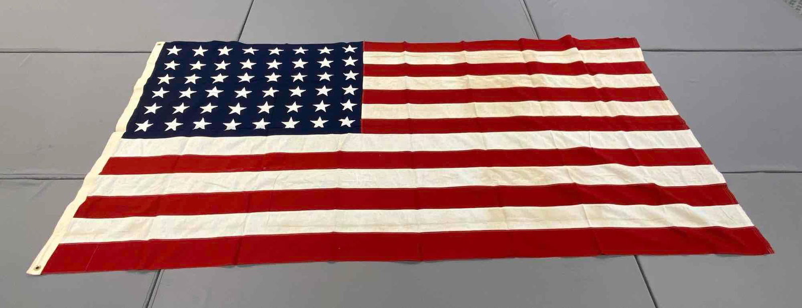 Large 48-Star American Flag: Measures 115x60 inches. 2 grommet hoist, machine stitched, some staining. Good condition.