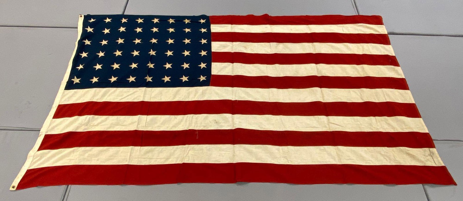 Large 48-Star American Flag: Measures 92x56inches. 2 grommet hoist, some staining, good condition.