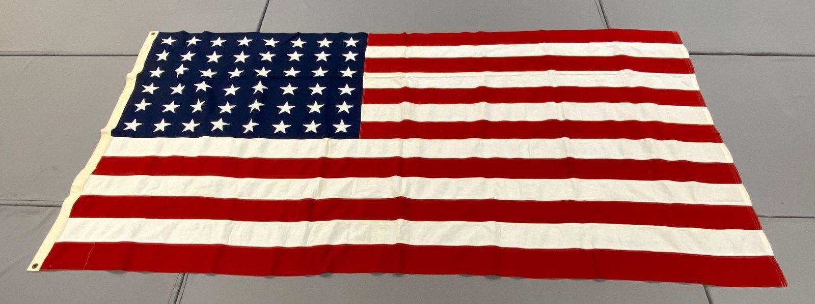 Large 48-Star American Flag: Measures 110x55 inches. Machine stitched, 2 grommet hoist, great condition.