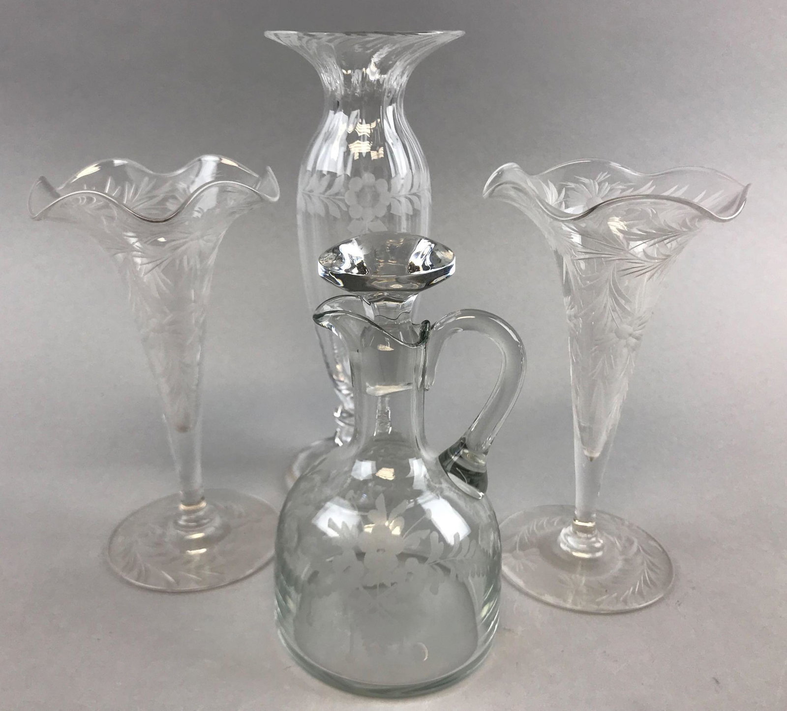 Group of 4 : Cut Glass Floral Pattern Items: Tallest is 7 3/4 inches. Lot includes a cruet, two trumpet vases, and an etched floral pattern vase; wear consistent with age