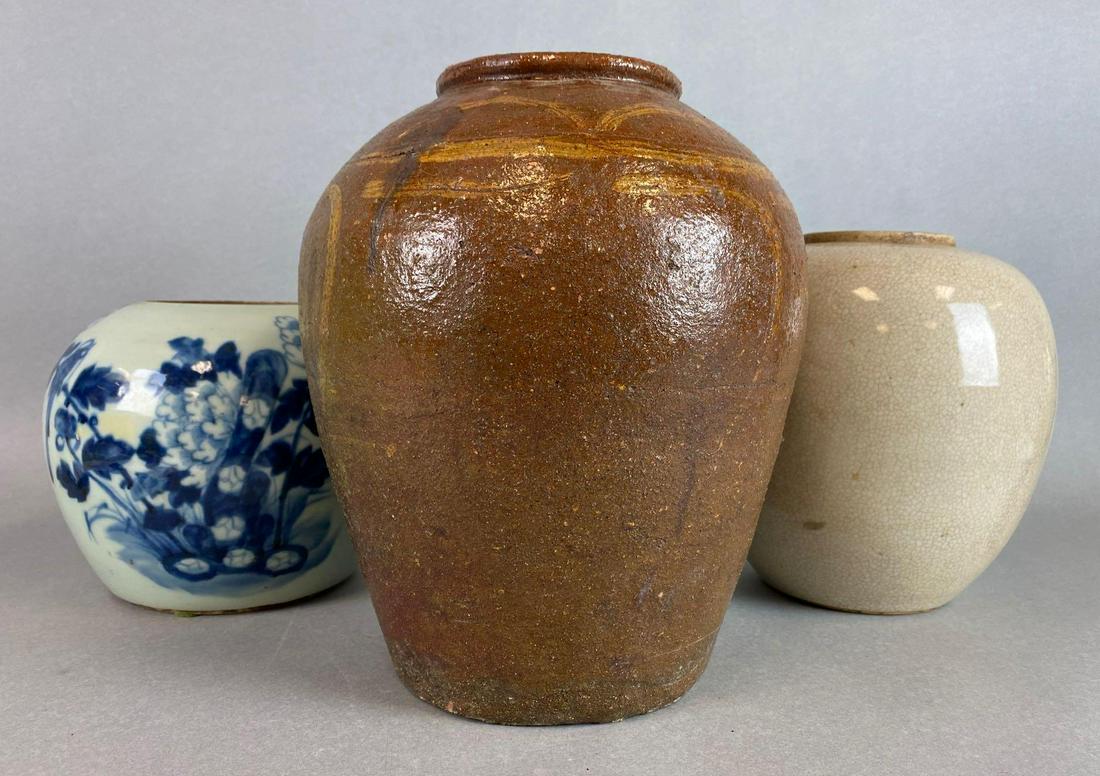 Group of 3 Chinese Ginger Jars: the Stoneware jar measures 11 x 9 inches. The white jar was made into a lamp. The blue and white jar has some chips.
