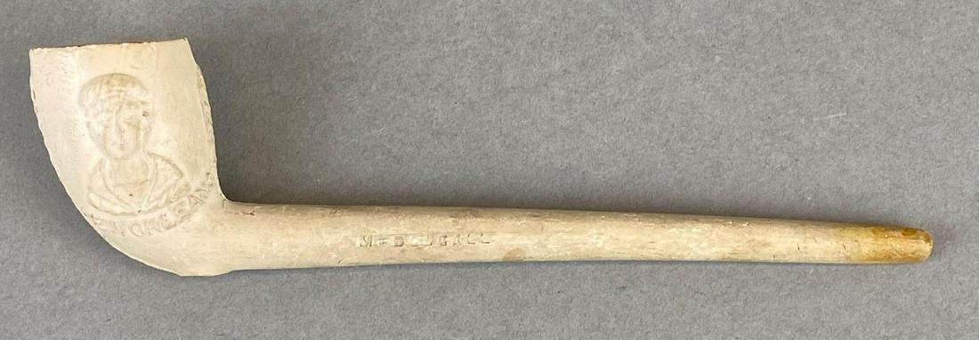 St. Vincents Seamans Haven Pipe: Marked along the stem with McDougall and Scotland. Pipe head has figure and New Orleans. Measures 6.5in long.