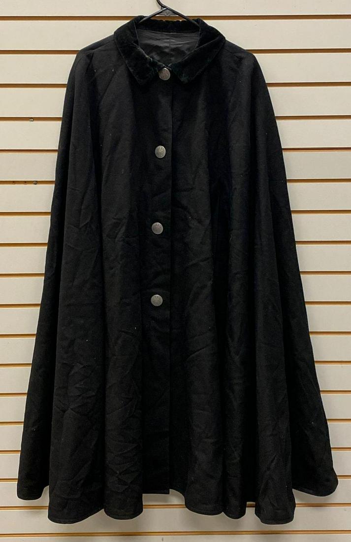 Black Wool Sleeveless Cape with Pope Buttons: Circa 1900s, silver toned buttons, measures 45in from collar to hem