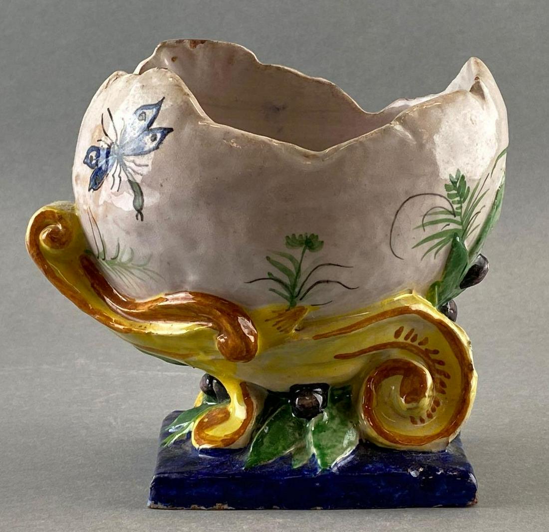 Decorative Painted Redware Egg-ShapedVessel: Vessel painted like a hatched egg on pedestal with flowers and insects. Measures 6.5in tall and wide. Some small cracks.