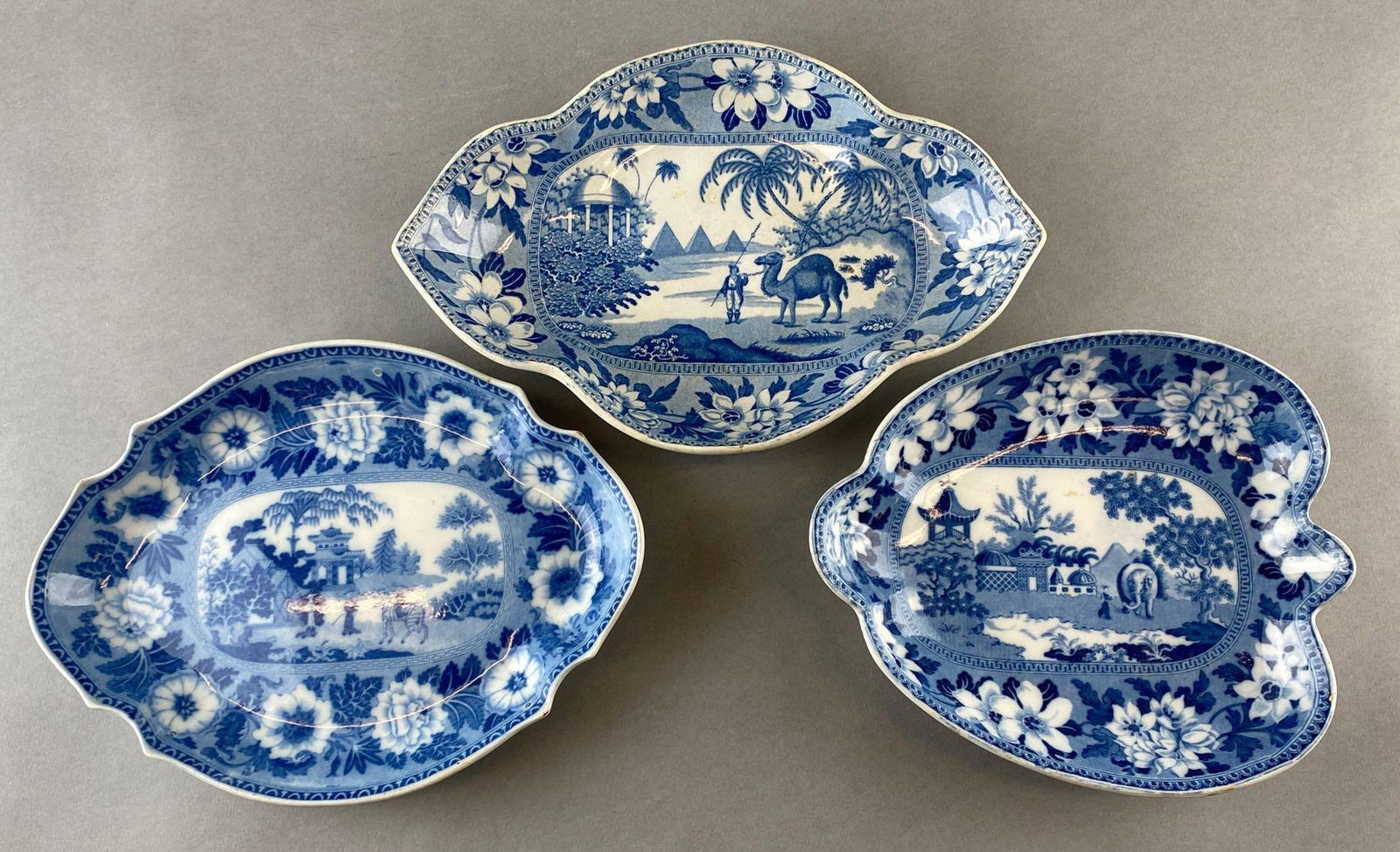 Group of 3 Blue and White Decorative Ceramic Dishes: Pronted animal scenes including zebra Rogers, camel Riley's, and elephant. Elephant has Rogers stamped on the back. Largest measures 11in long.