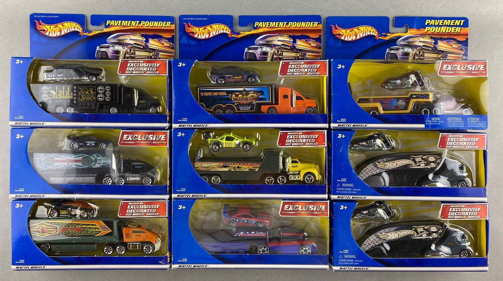 Group of 9 Hot Wheels Pavement Pounders die-cast vehicle sets: Hauler and exclusively decorated Hot Wheels vehicle, new in original packaging, some shelf wear