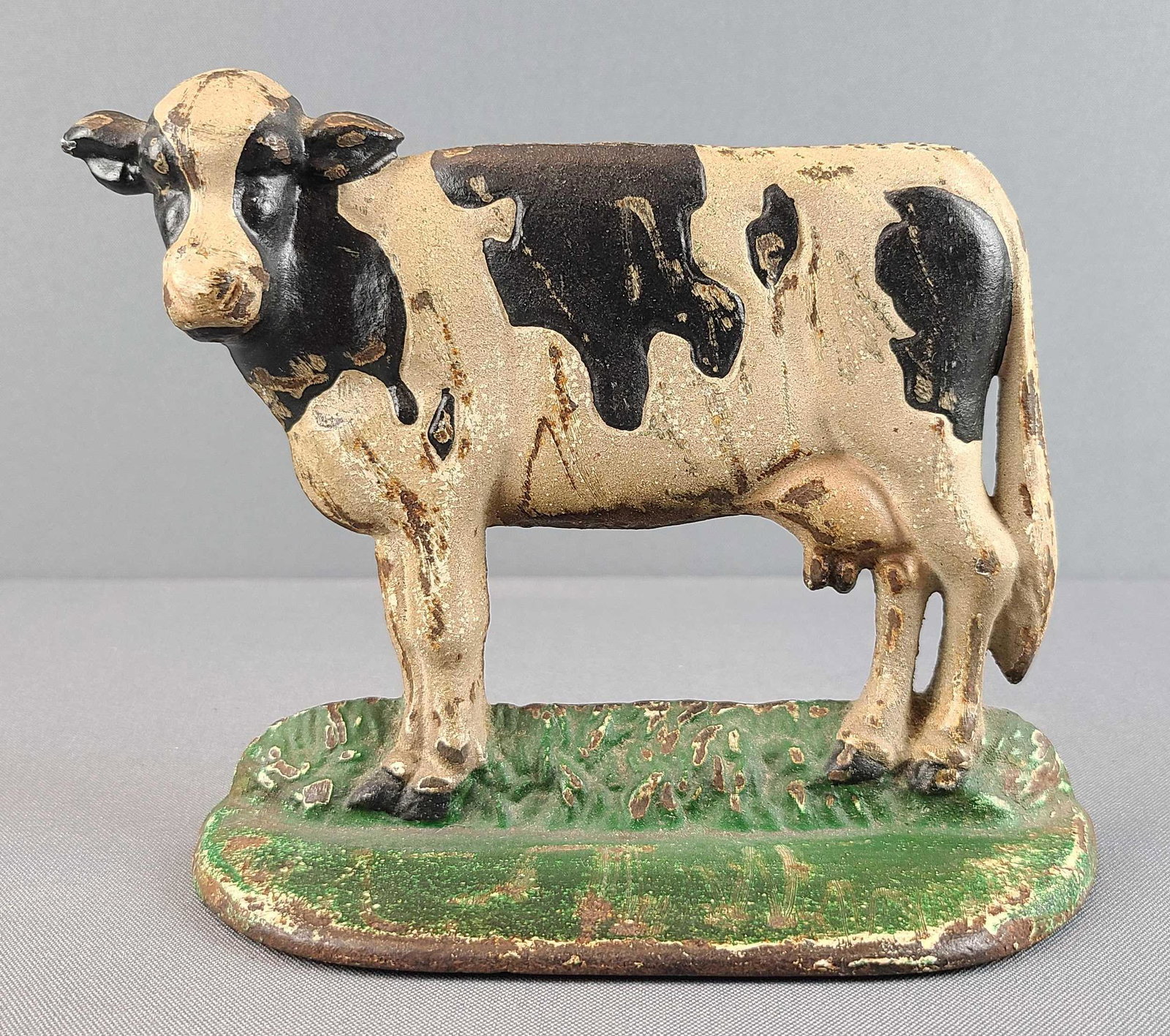Cast Iron Spotted Cow Door Stop: Some paint loss, rust. 6 x 7 x 2 1/2 inches
