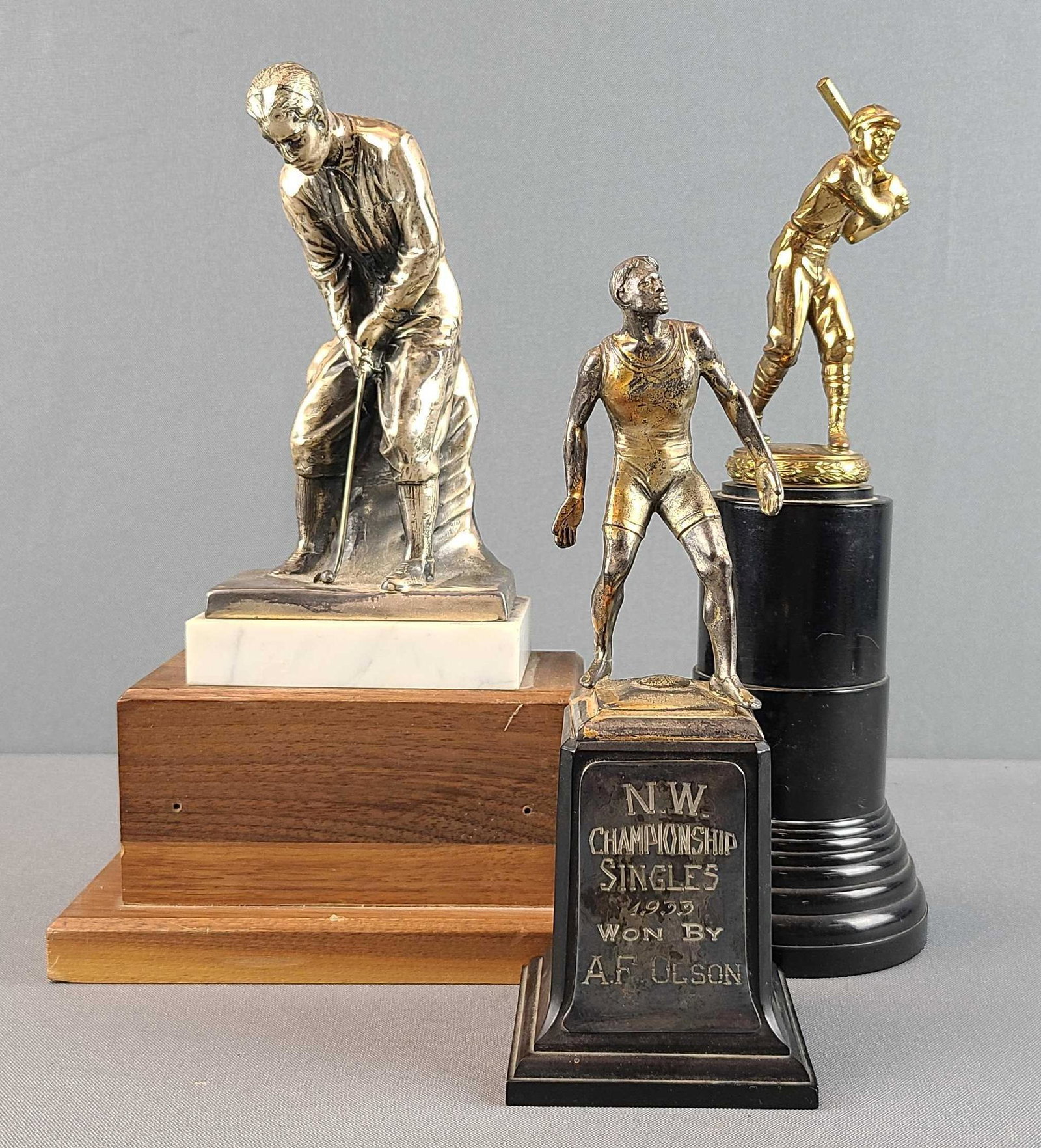 Group of 3 Sports Trophies: Largest stands 10 1/2 inches tall.