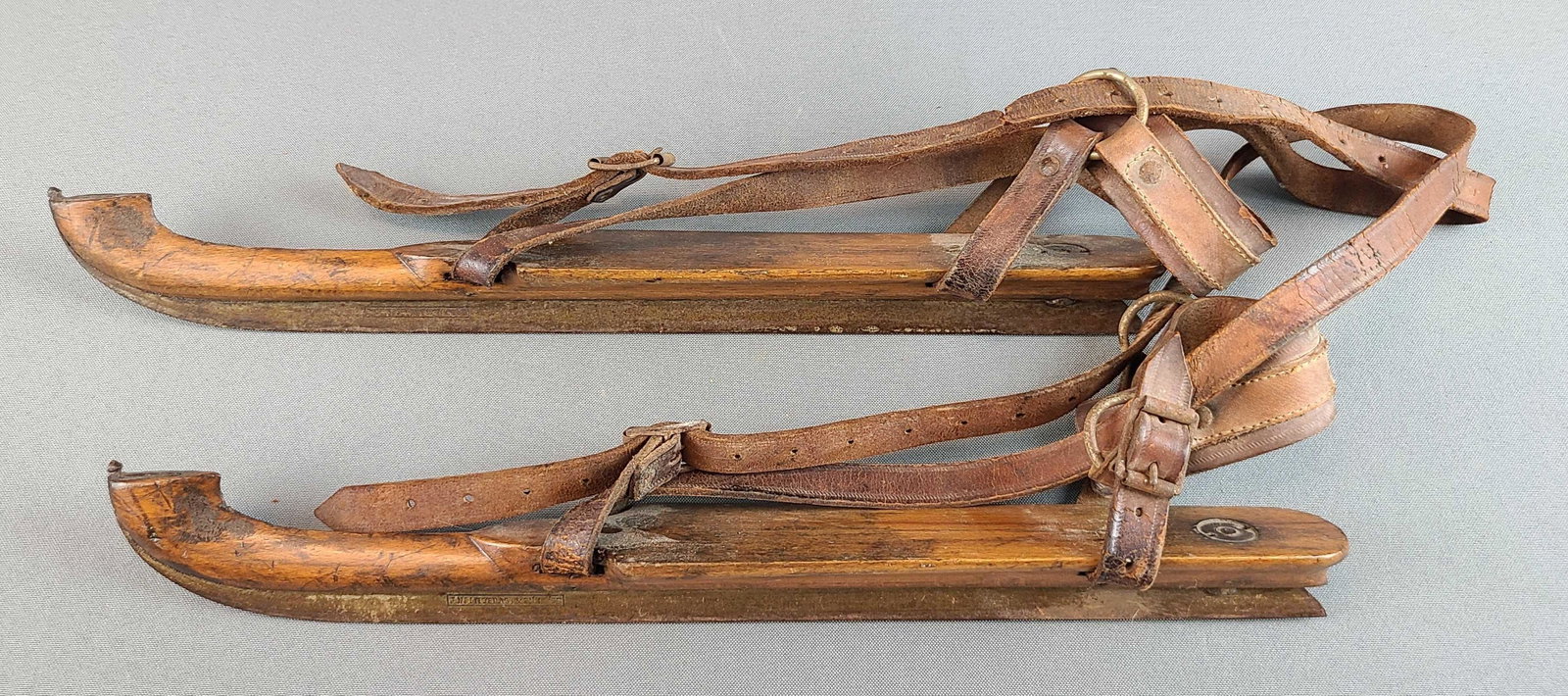 Antique Ice Skates: Wood with leather straps. 15 inches long