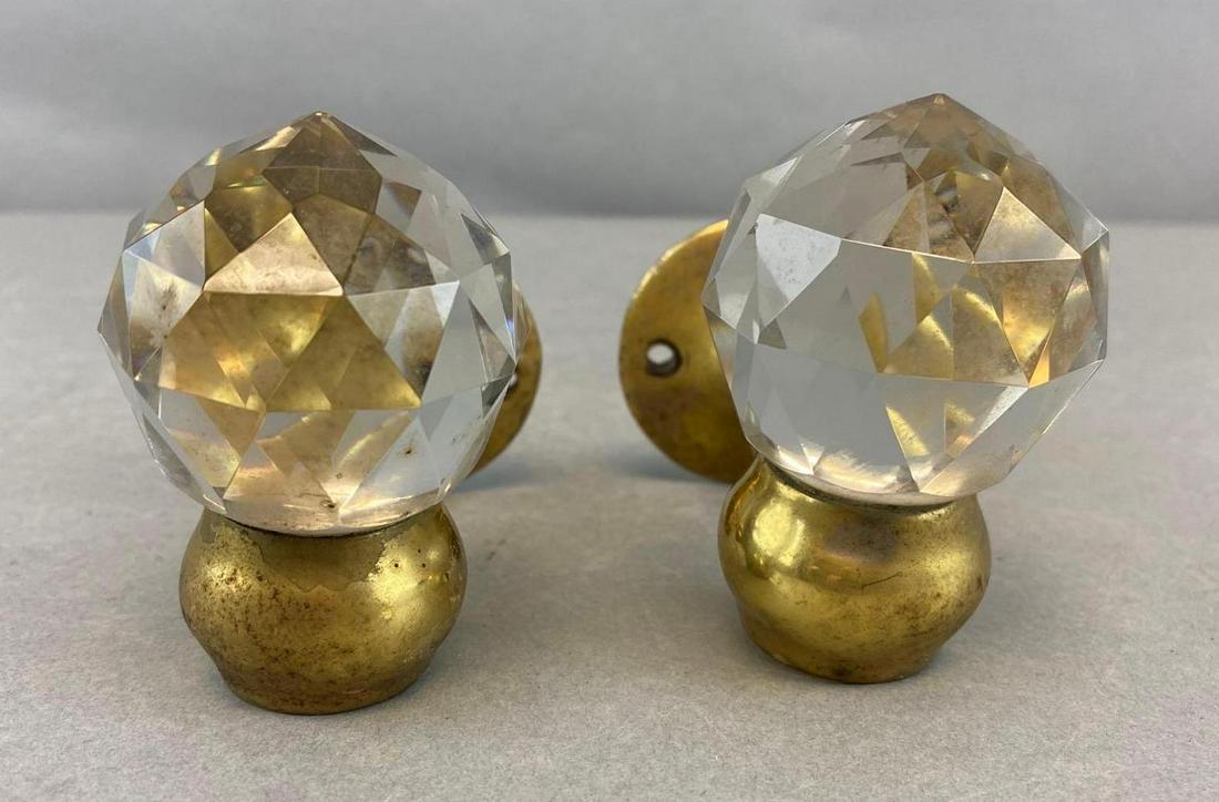 Group of 2 Art Brass Co. Coat Hangers: Brass. Reinforced at base. Star on bottom of one. 4 x 2 inches.