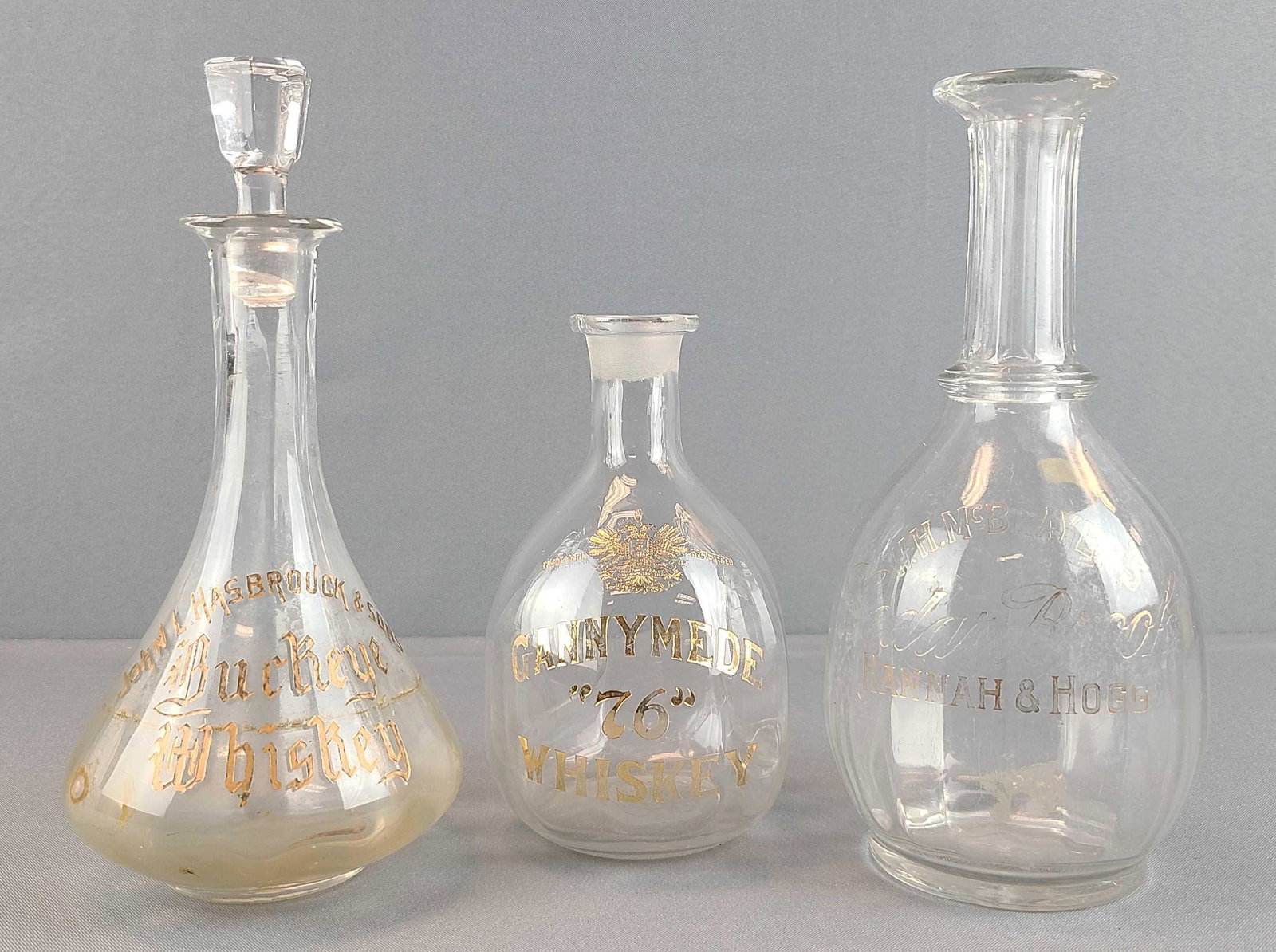 Group of 2 Pre-prohibition Bar Back Saloon Bottles: Whiskey and Rye liquor bottles. Top of 1 bottle is chipped. Tallest is 10 inches