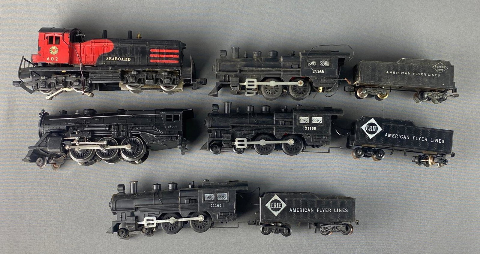 Group of 5 Assorted O Scale Locomotives and Tenders: Untested. Includes Erie American Flyer Lines, 21165, 602, and more. Some pieces missing/broken, some rust.
