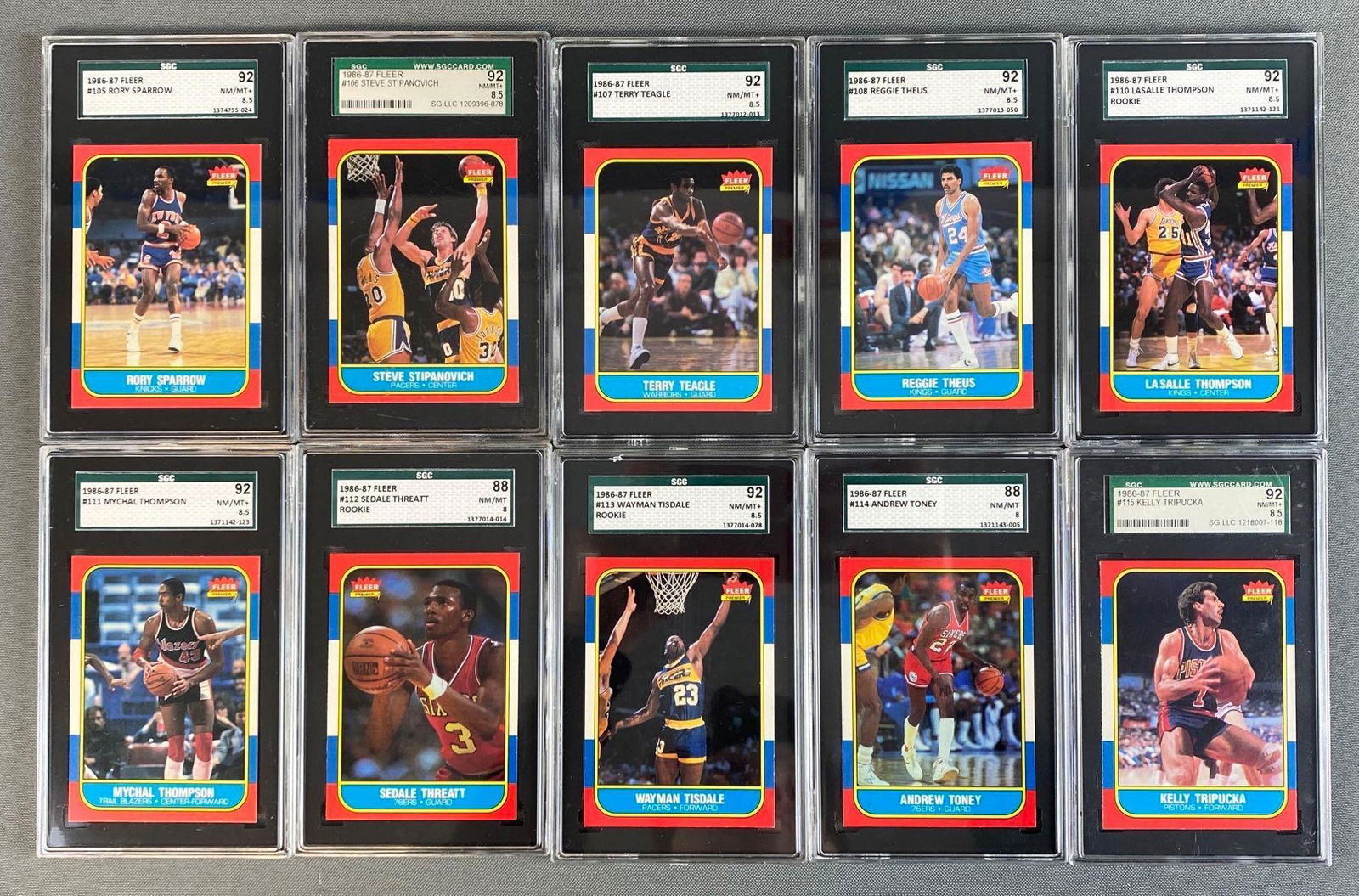 Group of 10 1986-87 Fleer Basketball Graded SGC 8 - 8.5: Set Break, cards #105-115, including Rory Sparrow, Steve Stipanovich, Terry Teagle, Reggie Theus, Lasalle Thompson, Michael Thompson, Sedale Threatt, Wayman Tisdale, Andrew Toney, and Kelly Tripucka.