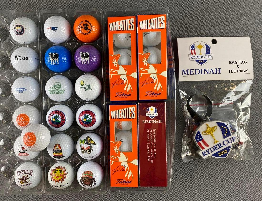 Group of Golf Balls and Ryder Cup Club Memorabilia: Includes 2012 Ryder Club bag tag and balls, 3 Wheaties Tiger Wood balls, and 19 specialty golf balls.