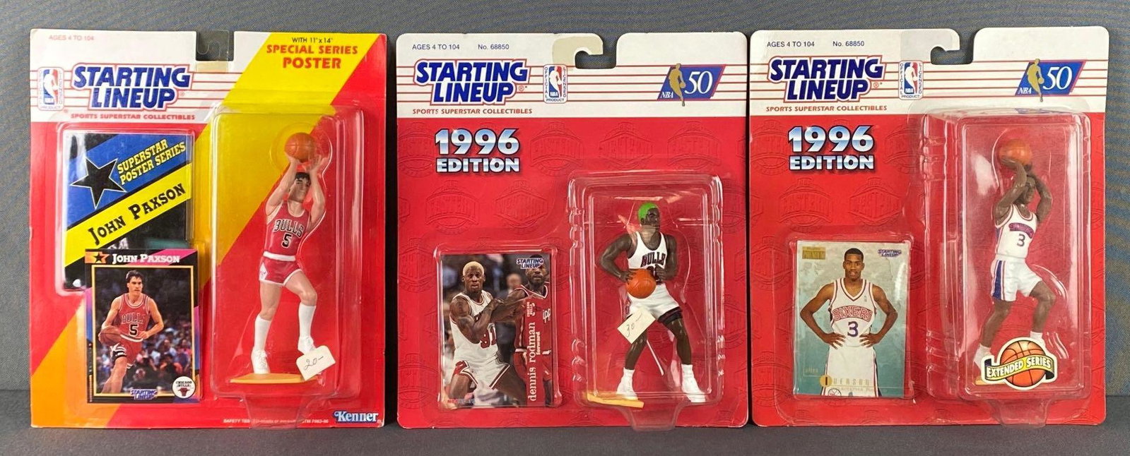 Group of 3 Starting Lineup Basketball Bulls Figures: All in original packaging with near mint-mint rookie cards, including 1992 John Paxson, 1996 Dennis Rodman, and 1996 Allen Iverson.