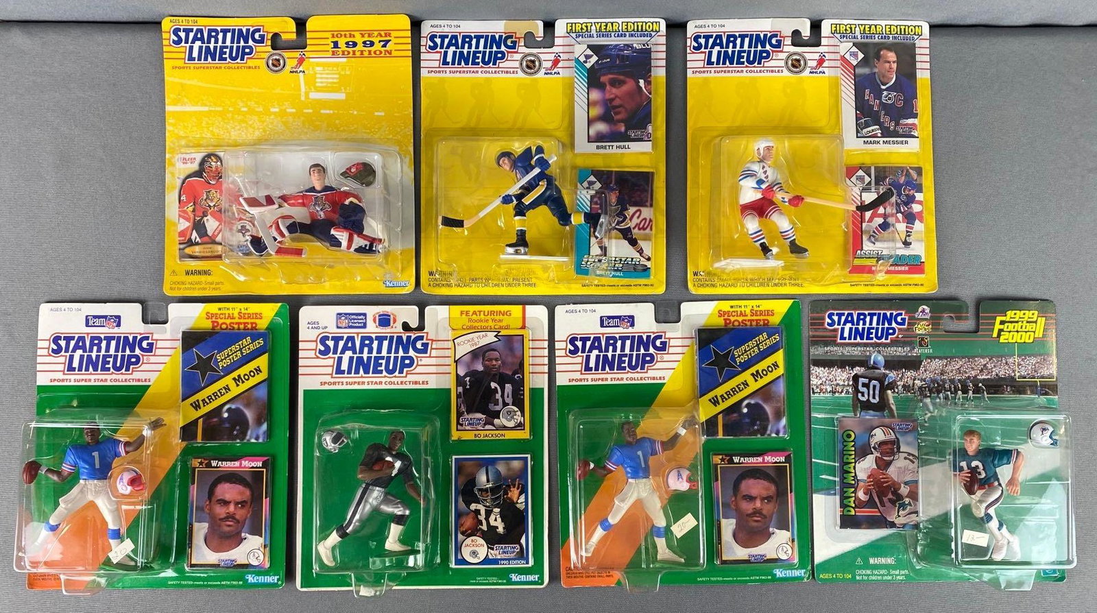 Group of 7 Starting Lineup Figures: All in original packaging with collectors cards, (3) NHL and (4) NFL, including (2) 1992 Warren Moon, 1990 Bo Jackson, 1999 Dan Marino, 1993 Mark Messier, 1993 Brett Hull, and 1997 John Vanbiesbrouck,