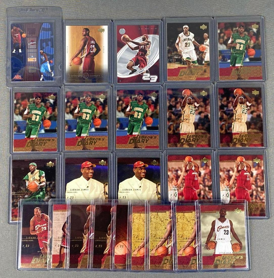 Group of 24 Lebron James Rookie Cards: Including 2003, Fleer Focus Tag Team Insert #13TT, 2003 Upper Deck #30, E-XL #53, and (21) 2003 Upper Deck Lebrons Diary Neon Set, great investment lot.