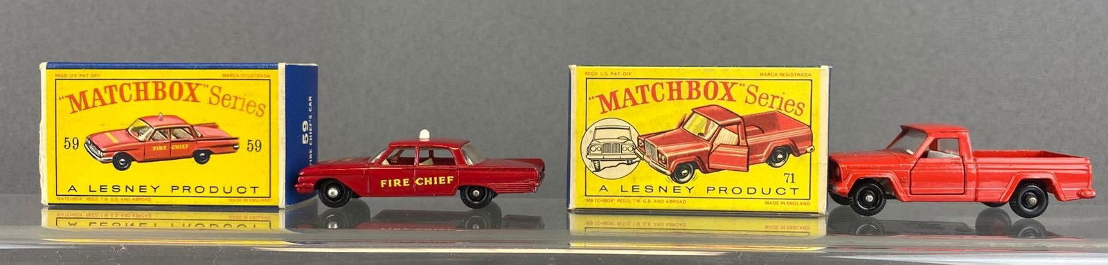 Group of 2 Matcbox Nos. 59 and 71: Red. Fire Chiefs Car and Jeep Gladiator Pick up Truck. A Lesney Product. Black plastic wheels. Original boxes. Made in England. Die-Casts.