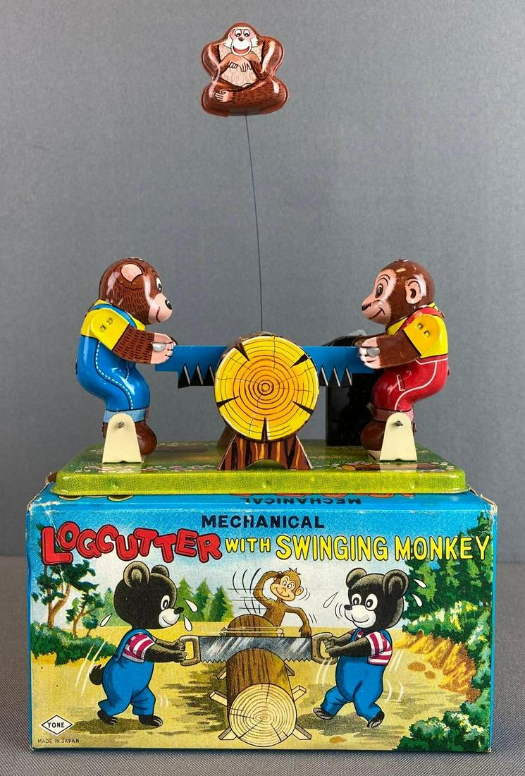 Yone Log Cutter with Swinging Monkey Tin Wind Up Toy: in working condition, with original box, 7 3/4 X 6 1/4 X 3 1/4 inches