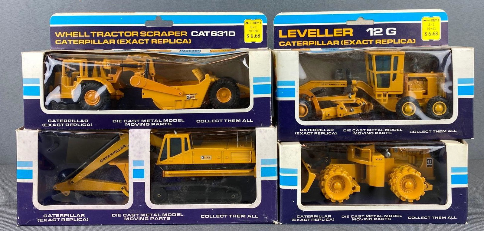 Group of 4 Caterpillar Die Cast Vehicles: all with original boxes. includes leveller, whell tractor scraper, hydraulic excavator, and compactor
