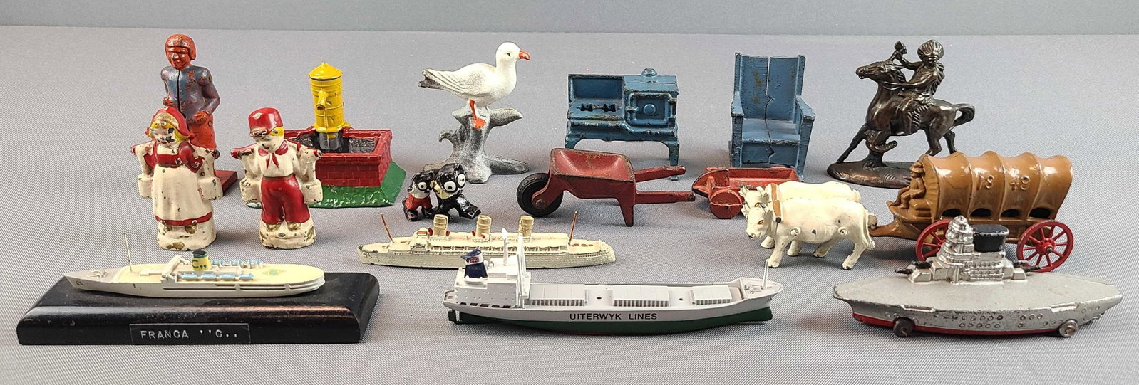 Group of 16 Cast Iron Toys and more: Steel, cast iron, and more. Covered wagon and ox measures 6 inches long