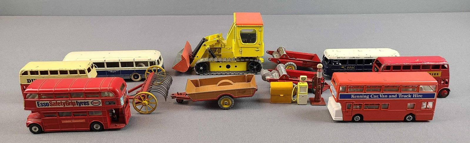 Group of 14 Dinky Toys Vehicles and Accessories: Buses, tractor equipment. Played with condition.