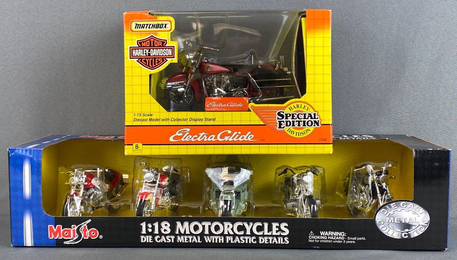 Group of 2 Die-Cast Motorcycle Sets: Includes 1993 Matchbox 1/15 scale Harley-Davidson Electra Glide, and 2001 Maisto 1/18 scale Motorcycle Collection, largest box measures 4 x 17 1/2 x 6in.