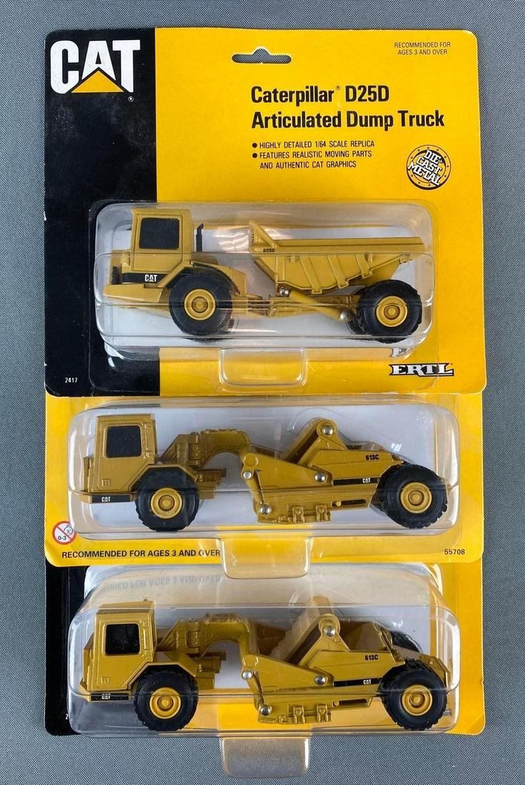 Group of 3 Die Cast Caterpillar Vehicles: includes D25D Articulated Dump Truck and 2 613C Scrapers, in original packaging, 1994 and 1998