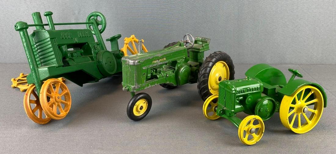 Group of 3 Die Cast John Deere Tractors: paint loss throughout, 1 has missing wheel, 1 has detached wheel, largest is 12 X 7 X 4 3/4 inches