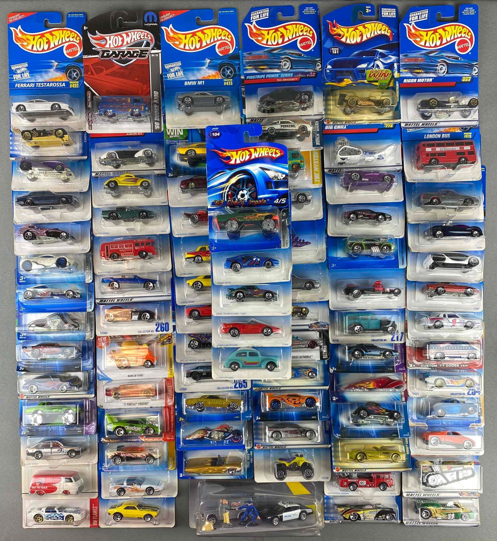Group of Mattel Hot Wheels Die Cast Vehicles: in original packaging. includes 1969 Dodge Charger Daytona, 1977 Pontiac Firebird, tooned 1969 Camaro, custom 1941 Willyâ€™s coupe, speed a Saurus, and more