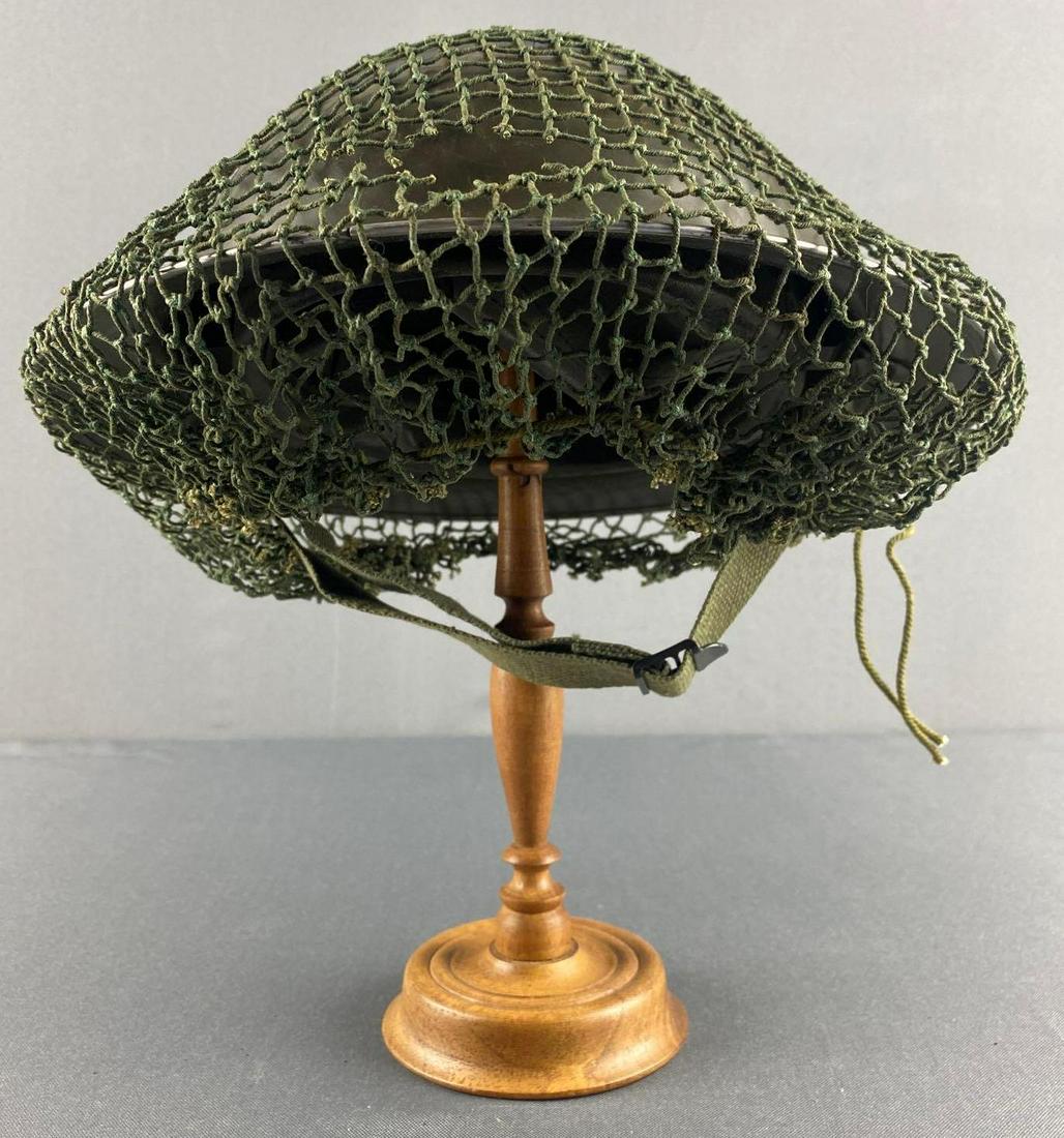 WW2 British Brodie Helmet with Camo Netting: 1942. No. 86 Mesh is ripped. Liner and chinstrap in tact. Approx. 6 inches tall, lining is 8 1/4 x 7 1/2 inches.