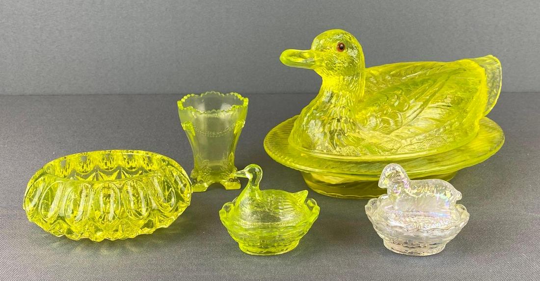 Group of Vaseline Glass Items: 4 vaseline glass, 1 iridescent glass covered dish, toothpick holder, covered dishes, and more. largest is 8 1/2 X 5 X 6 inches