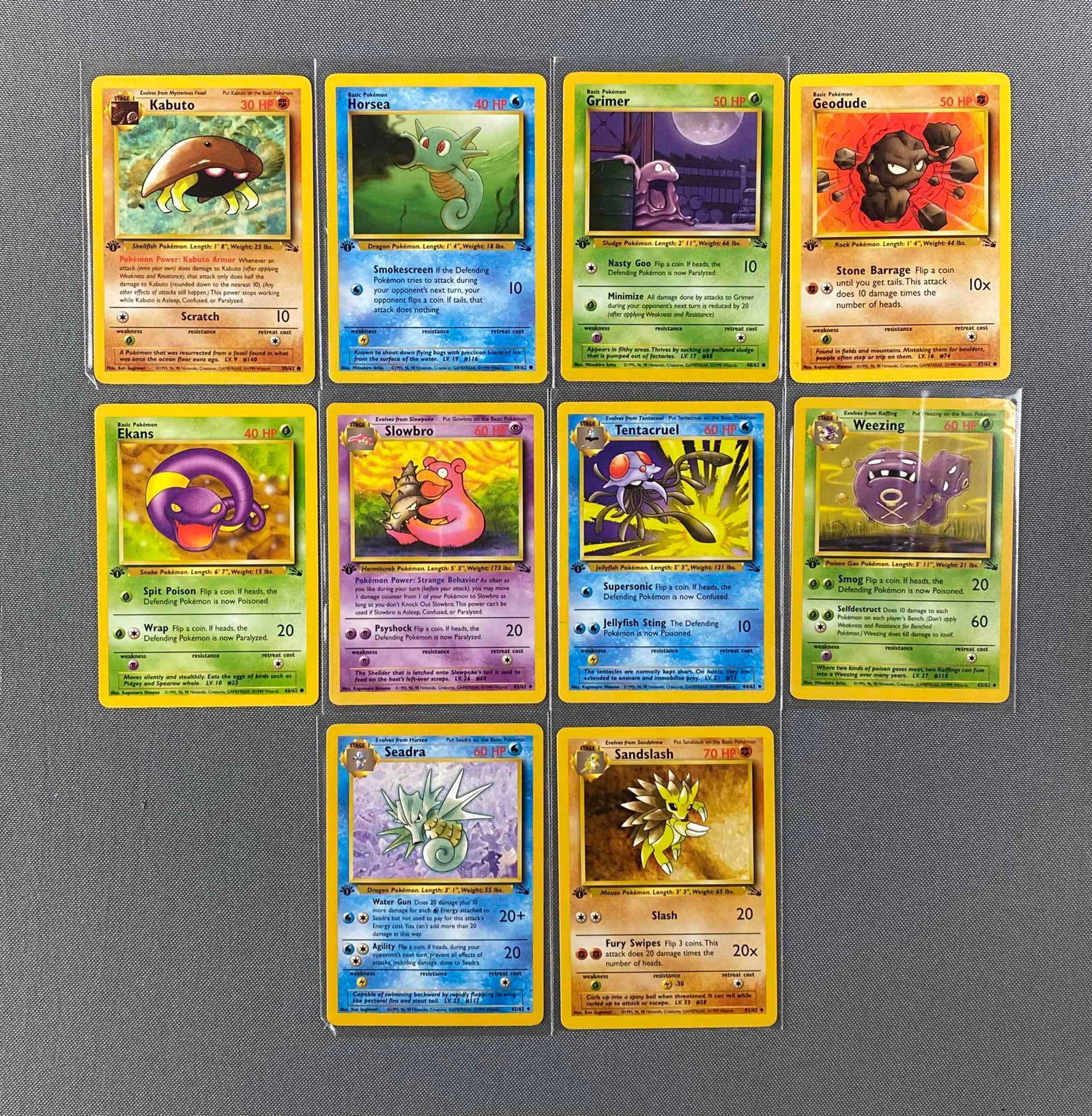 Group of 10 1999 Pokemon Fossil Set 1st Edition Cards: #48 Grimer, #44 Tentacruel, #41 Sandslash, #46 Ekans and more