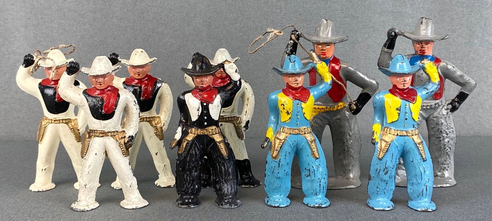 Group of 9 Barclay Cowboys: 1930s, made of lead, includes B250(#953), B249(#952), and B959(#752), some missing lassos and pistols, wear consistent with age, tallest measures 3 1/4in.