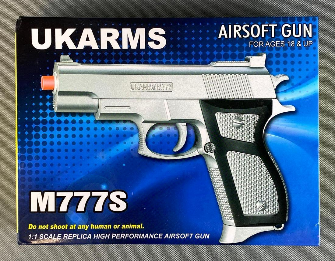 Ukarms M777S Airsoft Gun: 1/1 scale replica airsoft gun, in factory packaging, missing box base, untested, box measures 1 1/2 x 7 x 5 1/4in.