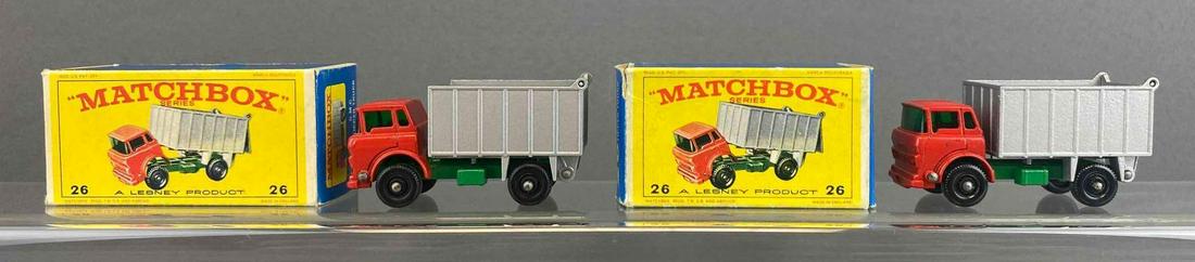 Group of 2 Matchbox No. 26 GMC Tipper Truck: Red. A Lesney Product. Black plastic wheels. Original box. Made in England. Die-cast.