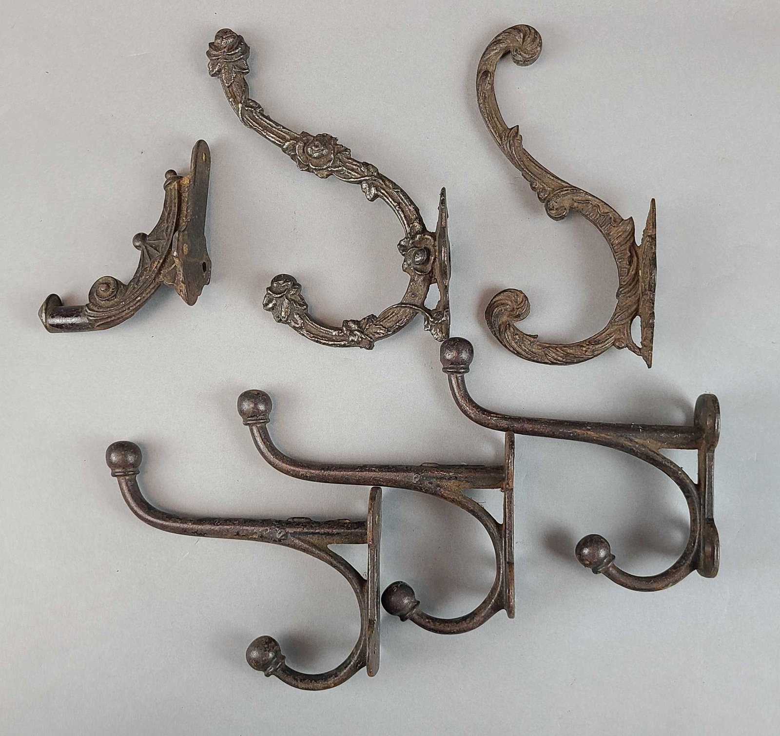 Group of 6 cast iron hooks: Largest is 5 x 7 inches