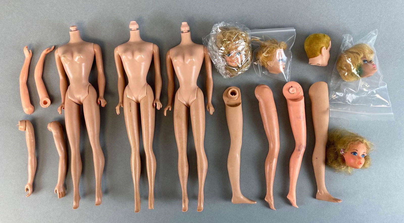 Group of 16 Mattel Barbie Replacement Parts: Includes bodies, limbs, and heads, bodies measure 10 1/2in tall.
