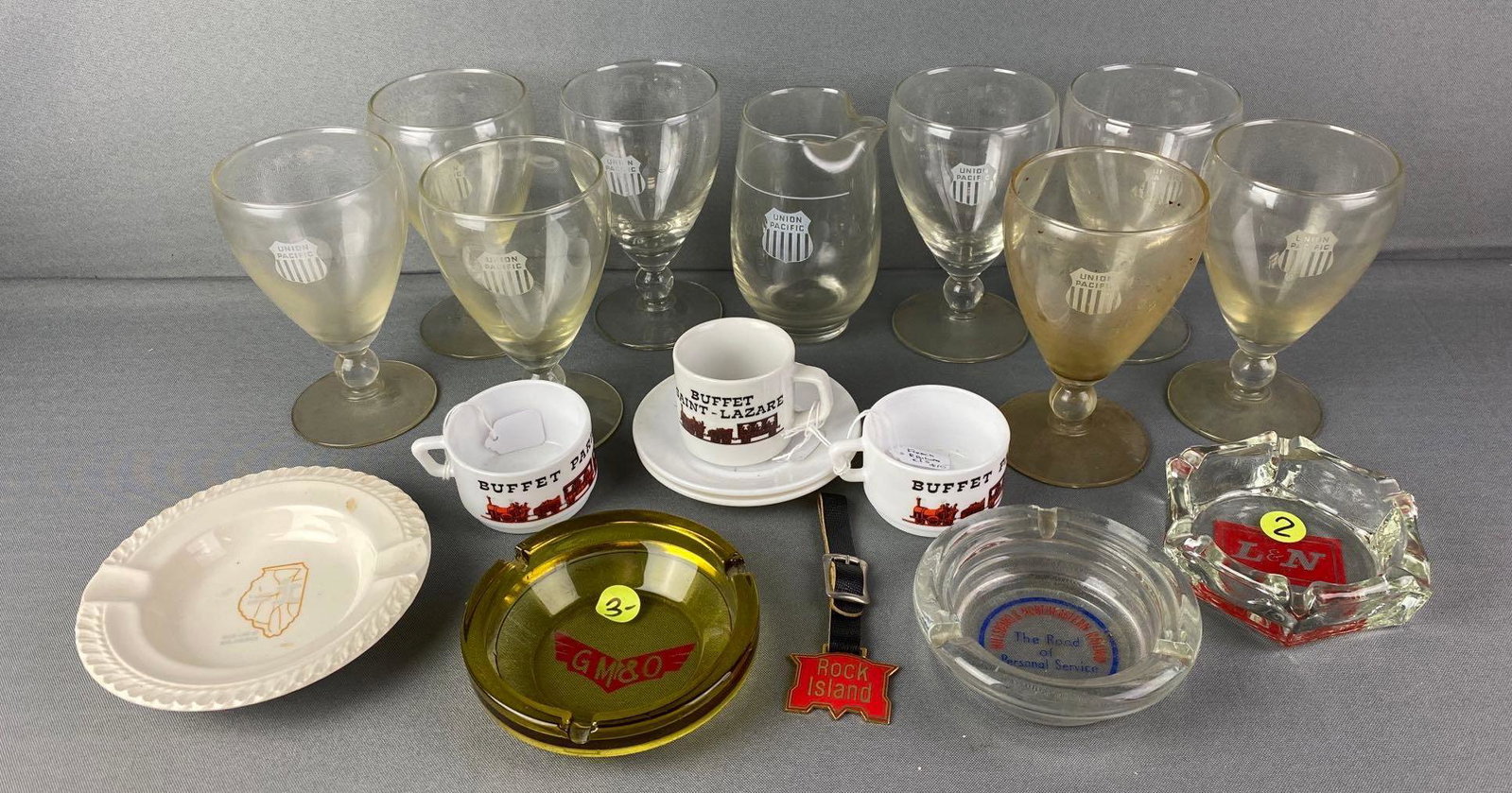 Group of 18 Assorted Train Dishes: Includes Union Pacific Cups, Buffet Saint - Lazare Cup, GMO Ash tray, and more. largest measures 5 1/2 x 3 1/4 inches.