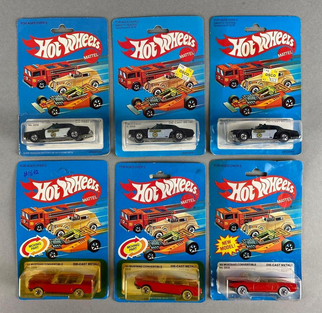 Group of 6 Hot Wheels Die-Cast Vehicles: Includes No. 2019 Sheriff Patrol, and No. 5908 1965 Mustang Convertible. Mattel. In original packaging. Packaging measures 6 1/2 x 4 1/4 x 1 1/2in.
