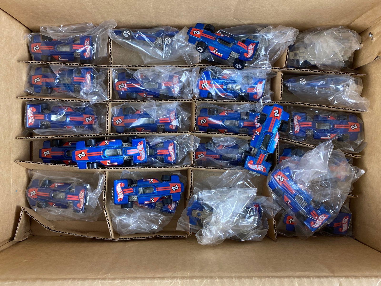 Group of 20+ Hot Wheels Die-Cast Race Cars: Mattel. In original factory box. All cars identical. Factory box measures 5 x 14 1/2 x 9 1/4in.
